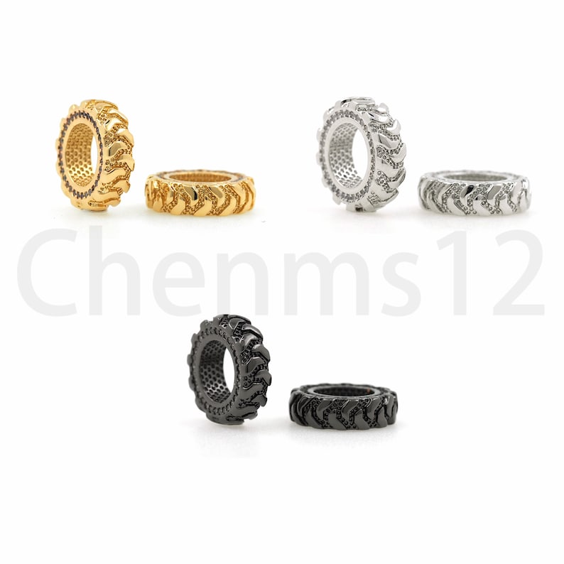 May include: Three pairs of tire-shaped rings, one pair in gold, one pair in silver, and one pair in black.