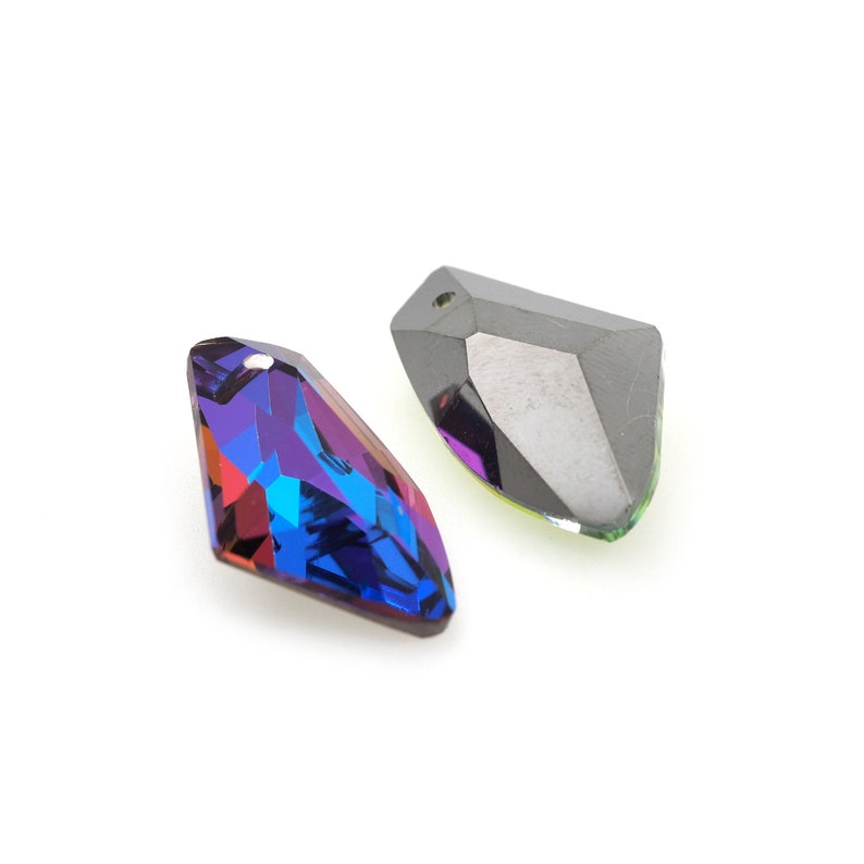 May include: Two iridescent crystal pendants, one is a teardrop shape with a blue and purple hue, the other is a more angular shape with a black and green hue.