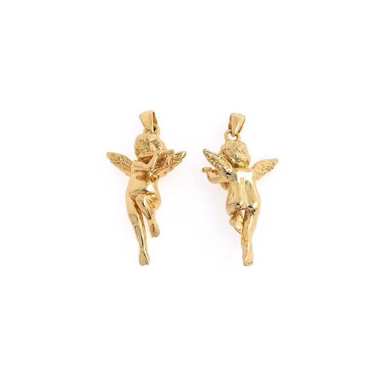 May include: A pair of gold cherub pendant charms. Each charm features a cherub with wings outstretched, one playing a musical instrument and the other with its wings spread.