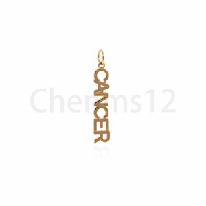 May include: Gold charm pendant with the word "Cancer" spelled vertically.