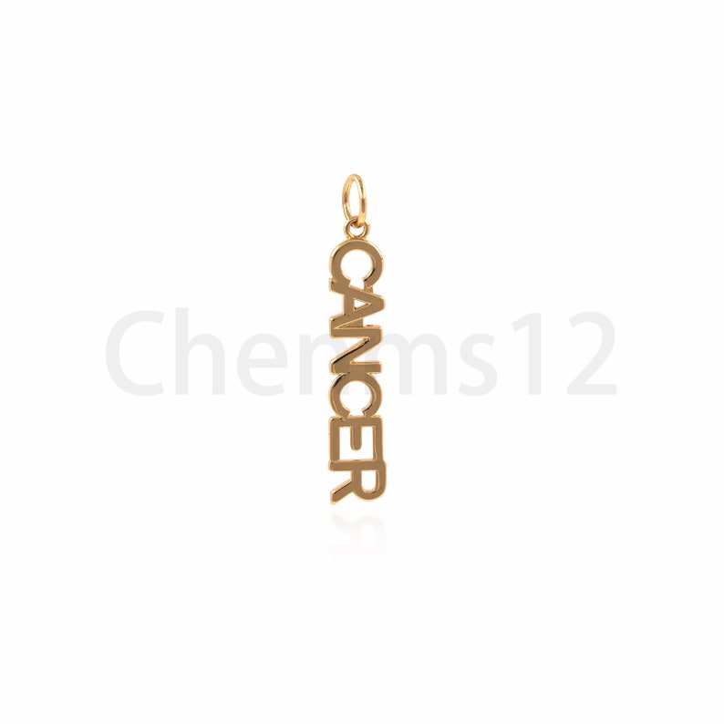 May include: Gold charm pendant with the word "Cancer" spelled vertically.