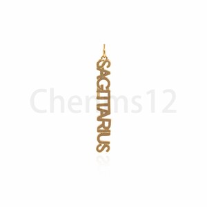 May include: Gold pendant necklace with the word "SAGITTARIUS" spelled vertically.