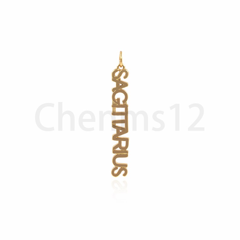 May include: Gold pendant necklace with the word "SAGITTARIUS" spelled vertically.