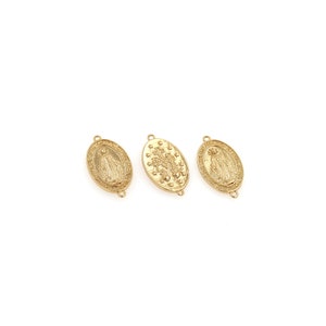 May include: Three gold-colored oval pendants with religious imagery. Each pendant features a detailed embossed design, including figures and symbols. The pendants have small loops for attaching to a chain or other jewelry components.