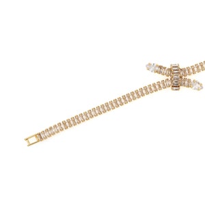 May include: A gold chain necklace with a delicate, interwoven design featuring clear baguette-shaped crystals.