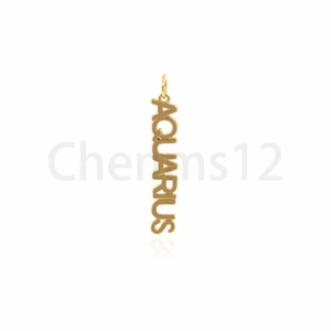 May include: Gold pendant charm with the word "Aquarius" spelled vertically.