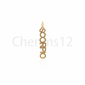May include: Gold-colored pendant necklace with the word "SCORPIO" spelled vertically.