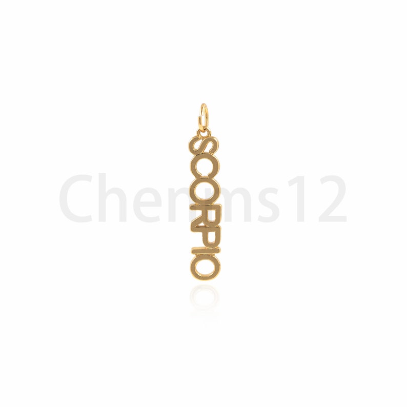 May include: Gold-colored pendant necklace with the word "SCORPIO" spelled vertically.