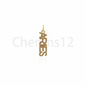 May include: Gold-colored pendant charm with the word "ARIES" spelled vertically.