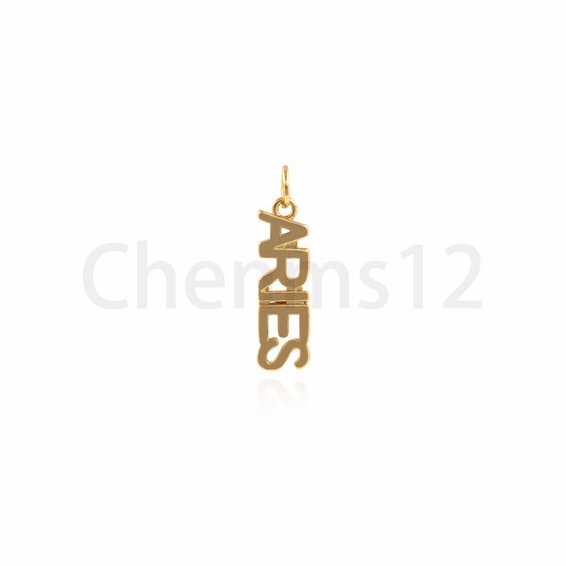 May include: Gold-colored pendant charm with the word "ARIES" spelled vertically.