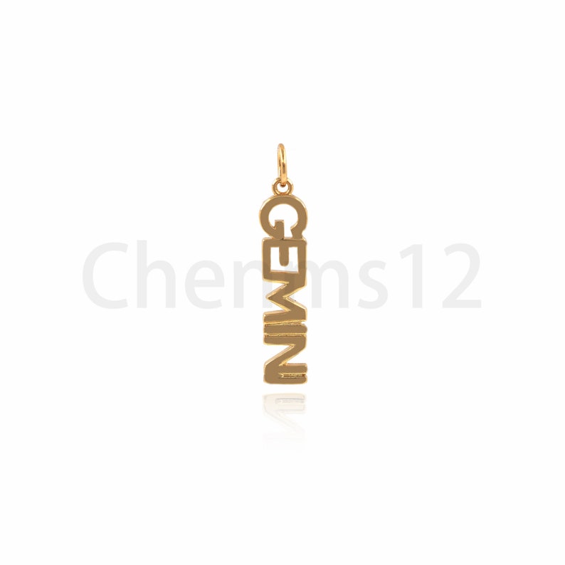 May include: Gold-colored pendant charm with the word "GEMINI" spelled vertically.