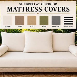 May include: A hanging wooden daybed with a thick off-white mattress and three large square cushions, plus two cylindrical bolster pillows. Above, a sign reads SUNBRELLA OUTDOOR MATTRESS COVERS with color swatches: Natural, Taupe, Flax, Fern, Charcoal, and Cabana Stripe.