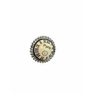 May include: A round button featuring a cream-colored clock face design with black Roman numerals and the word Paris printed in the center. The button has a textured, scalloped silver-toned metal border surrounding the circular clock graphic.