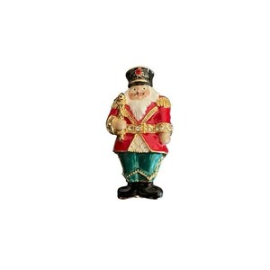 May include: A nutcracker brooch featuring a red jacket with gold trim, green trousers, and black boots. The figure wears a black hat with a red stone, has a white beard, and holds a gold staff. The belt and staff are accented with clear crystals.