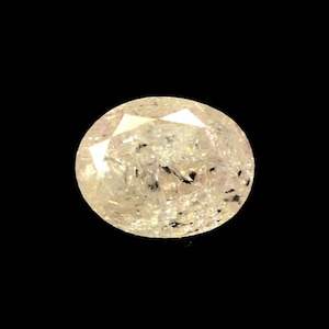 May include: A round, clear, faceted gemstone with a light pink hue. The gemstone has a slightly cloudy appearance.