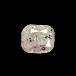 May include: A clear, faceted, cushion-cut diamond with a light pink hue.