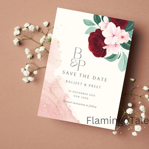 May include: Save the date card with a pink and gold watercolor background. The card features a floral design with red and pink flowers and green leaves. The text on the card reads "B & P Save the Date Baljeet & Preet 30 November 2030 New York Formal invitation to follow Flamingo Tales".