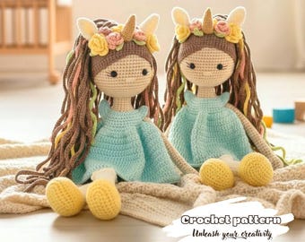 May include: Two handmade crochet dolls with long brown hair, wearing blue dresses and flower crowns. Each doll has yellow crocheted feet and is sitting on a beige blanket. The text "Crochet pattern Unleash your creativity" is at the bottom.