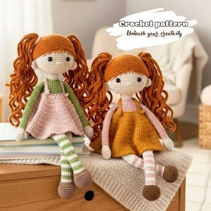 May include: Two handmade crochet dolls with red curly hair, wearing dresses and striped leggings. One doll has a pink dress and green straps, the other has an orange dress. The dolls are sitting on a wooden surface. Text on the image reads "Crochet pattern Unleash your creativity."