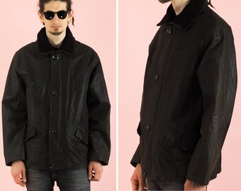 May include: A black leather jacket with a corduroy collar and button closure. The jacket has two pockets on the front and a zippered closure.