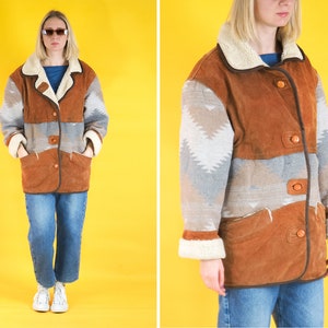 May include: A brown suede jacket with a white and grey patterned design. The jacket has a faux fur collar and a button closure.