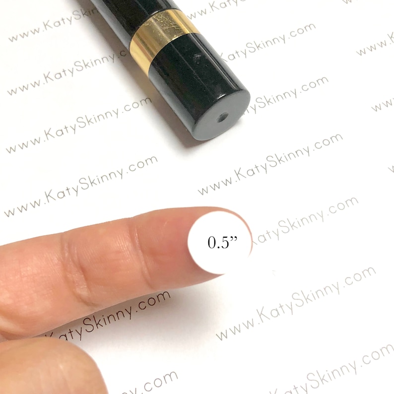 May include: A black and gold tube with a white circle sticker that says "0.5" inches.