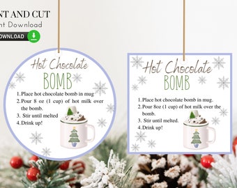 May include: Two printable tags for hot chocolate bombs, one circular and one square. Each features instructions and a mug graphic. The text reads "Hot Chocolate Bomb" and includes instructions. The tags are decorated with snowflakes.