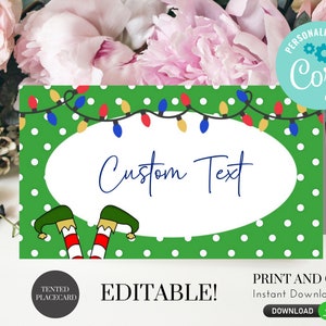 May include: Editable Christmas place card template with a green background, white polka dots, and a string of colourful lights. The text "Custom Text" is in a white oval with a cartoon elf's legs sticking out from the bottom.
