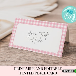 May include: Printable pink and white gingham place card with the text "Your Text Here" and a blue circle with the text "PERSONALIZE WITH Corjl!" in the upper right corner.