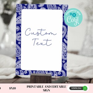 May include: A printable sign with a white background and a navy blue paisley border. The sign features the words "Custom Text" in a handwritten font. The sign is displayed on a wooden block. The sign is available in 5x10 and 8x10 sizes.