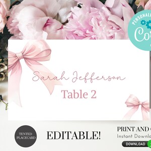 May include: Editable pink and white table card with a pink bow and the text "Sarah Jefferson Table 2".