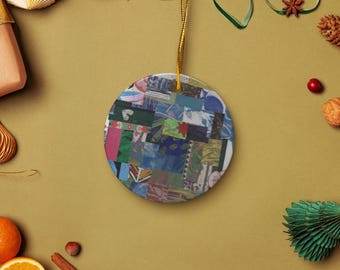 May include: A circular Christmas tree decoration with a patchwork design in shades of blue, green, pink, and white. It has a gold hanging string. Festive holiday decor.