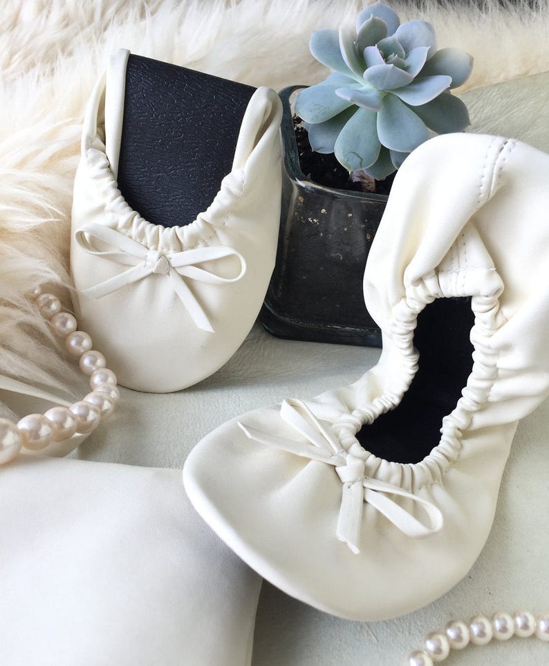 white foldable ballet flats