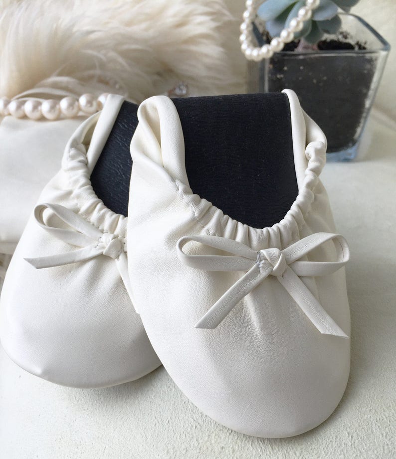 white foldable ballet flats