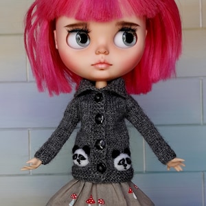 May include: A doll with pink hair wearing a gray cardigan with panda appliques and a brown skirt with mushroom embroidery.