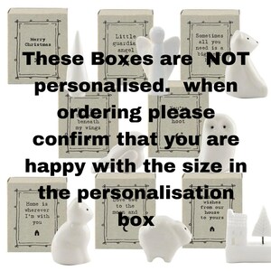 May include: A collection of white ceramic figurines, including an angel, owl, polar bear, and cat, each paired with a small box. The boxes have text such as "Merry Christmas" and "Home is wherever I'm with you". The text on the image says "These Boxes are NOT personalised."
