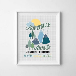 May include: A cross-stitch pattern with a mountain scene and the text "Adventure Awaits" with a baby's name, birthdate, time, and weight.