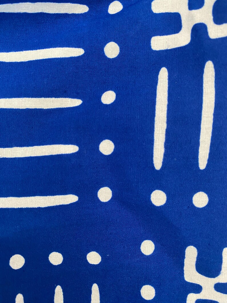 May include: Blue fabric with a white geometric pattern. The pattern includes circles, lines, and abstract shapes.