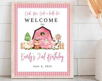May include: A pink and white gingham welcome sign with a red barn and farm animals. The text reads "Oink, Moo, Cock-a-doodle-doo! Welcome to Everly's 2nd Birthday June 4, 2024".