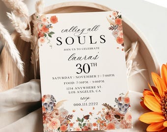 May include: A printed invitation with the text "calling all SOULS" and "laura's 30th". The invitation features floral and butterfly accents with a skull graphic. The color palette includes peach, orange, and cream.