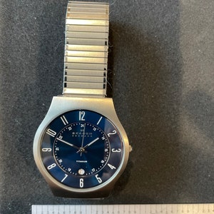 Vintage 1990’s men’s stainless steel titanium Skagen Denmark date and time thin dress wristwatch 233XLTTN, WI1110XE N - works!