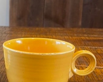1936-1949 Vintage Genuine Fiestaware 3” Homer Laughlin Original coffee cup in yellow - has some wear present.