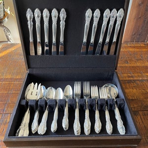 Beautiful vintage, 1995 Oneida Calilily silver flatware set in original brown box - would make a beautiful wedding gift!