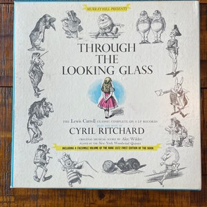 May include: A vintage record album cover featuring illustrations of characters from "Through the Looking Glass" by Lewis Carroll. The cover is white with black and white illustrations and features the title "Through the Looking Glass" in black text. The album is by Cyril Ritchard and includes a facsimile volume of the rare 1872 first edition of the book.