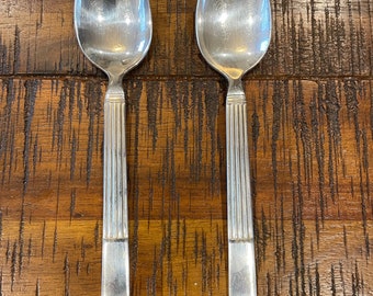 Two Vintage 1950’s Hotel silver side spoons stamped “W over M,” 60, a diamond and a hallmark - column  design measures 6” long