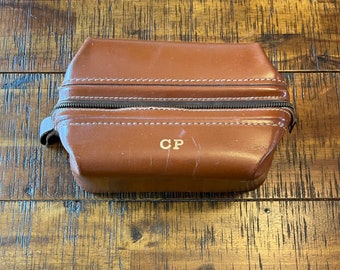 Vintage 1950s men’s toiletry kit, leather zippered, and in good shape and includes the letters CP monogrammed on the top