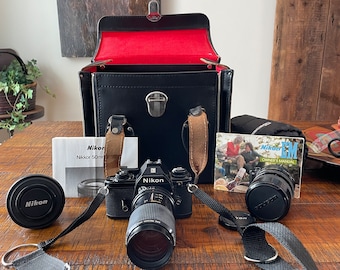 Vintage 1979 Nikon EM, interchangeable lenses, 35mm Single SLR - in black hard sided leather case