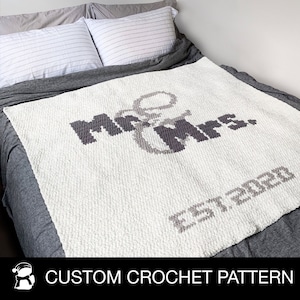 May include: White crochet blanket with the words "Mr & Mrs. Est 2020" in gray yarn.