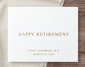 May include: White card with gold lettering that reads "Happy Retirement" followed by "Nancy Kendrick, M.D. March 22, 2024".