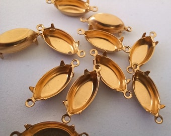 May include: A group of ten gold-toned metal oval-shaped settings with prongs for holding cabochons. The settings have three loops on each side for attaching to jewelry.